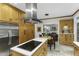 Open concept kitchen features stainless appliances, island cooktop, eat-in dining, and open view to living area at 2325 Old Oak Pl, Hillsborough, NC 27278
