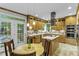 Bright kitchen with stainless steel appliances, island, light-colored cabinets, and access to the outdoor deck at 2325 Old Oak Pl, Hillsborough, NC 27278