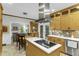 Kitchen with stainless appliances, eat-in dining, tile backsplash, island cooktop, and access to living room at 2325 Old Oak Pl, Hillsborough, NC 27278
