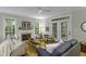 Inviting living room featuring a fireplace, hardwood floors, comfortable seating, and bright natural lighting at 2325 Old Oak Pl, Hillsborough, NC 27278