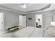 Large bedroom with a tray ceiling, soft carpet, and an adjoining bathroom and walk-in closet at 2325 Old Oak Pl, Hillsborough, NC 27278