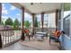 Relaxing back porch with wicker furniture and views of the backyard and trees at 2333 Lantern Walk Ln, Wake Forest, NC 27587