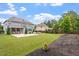 The backyard has a large grassy area, patio with outdoor seating, and lush landscaping at 2333 Lantern Walk Ln, Wake Forest, NC 27587