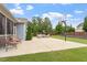Beautiful backyard featuring a concrete patio with outdoor seating and a basketball hoop at 2333 Lantern Walk Ln, Wake Forest, NC 27587
