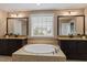Bathroom highlighting the soaking tub, dual vanities, and natural light from a window at 2333 Lantern Walk Ln, Wake Forest, NC 27587