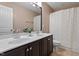 Bathroom featuring double sinks, dark wood vanity, and a shower tub combo at 2333 Lantern Walk Ln, Wake Forest, NC 27587
