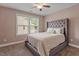 Bedroom showcasing neutral walls and carpeting with a large headboard at 2333 Lantern Walk Ln, Wake Forest, NC 27587