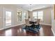 Elegant dining room featuring a chandelier, hardwood floors, natural light from large windows, and neutral paint at 2333 Lantern Walk Ln, Wake Forest, NC 27587