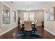 Dining room with hardwood floors, large windows, chandelier, and neutral paint at 2333 Lantern Walk Ln, Wake Forest, NC 27587