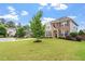 Beautiful two story home with a well manicured lawn, stone and brick exterior, and nice curb appeal at 2333 Lantern Walk Ln, Wake Forest, NC 27587