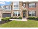 Up close view of a beautiful two story home with a well manicured lawn, stone and brick exterior at 2333 Lantern Walk Ln, Wake Forest, NC 27587