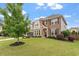 This home features a brick and stone facade with professional landscaping and a spacious driveway at 2333 Lantern Walk Ln, Wake Forest, NC 27587