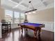 Well lit game room with hardwood floors, coffered ceilings, large windows, and pool table at 2333 Lantern Walk Ln, Wake Forest, NC 27587
