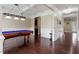 A billiard table and hardwood floors add luxury to this entertainment space with adjacent sitting area at 2333 Lantern Walk Ln, Wake Forest, NC 27587