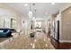 Large kitchen island featuring granite countertops, stainless appliances and open to dining and living areas at 2333 Lantern Walk Ln, Wake Forest, NC 27587