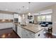 Bright and airy kitchen features stainless steel appliances, granite counters and is open to the living room at 2333 Lantern Walk Ln, Wake Forest, NC 27587