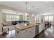 Open concept kitchen featuring an island with seating, stainless steel appliances, and views to the living and dining areas at 2333 Lantern Walk Ln, Wake Forest, NC 27587