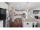 Well-appointed kitchen with stainless appliances, granite counters and large island open to the living room at 2333 Lantern Walk Ln, Wake Forest, NC 27587