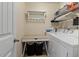 Laundry room with a folding table, hanging rack, and washer/dryer at 2333 Lantern Walk Ln, Wake Forest, NC 27587