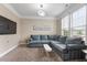 Comfortable living room with a plush sectional sofa, carpet and large windows at 2333 Lantern Walk Ln, Wake Forest, NC 27587