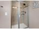 Modern shower showcasing tiled walls, glass enclosure, and built-in shelving at 2333 Lantern Walk Ln, Wake Forest, NC 27587