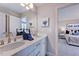 Bathroom featuring a double sink vanity, modern fixtures, and a view into an adjacent bedroom at 2512 Stonington Dr, Cary, NC 27523