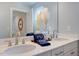 Elegant bathroom featuring dual sinks, a wide mirror and modern fixtures, creating a luxurious space at 2512 Stonington Dr, Cary, NC 27523