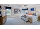 Spacious bedroom featuring a tray ceiling, neutral decor, and large windows at 2512 Stonington Dr, Cary, NC 27523