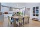 Open dining area with a wooden table, modern lighting, and easy access to the kitchen at 2512 Stonington Dr, Cary, NC 27523