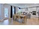 Bright dining area with a wooden table, modern lighting, and access to the outdoor patio at 2512 Stonington Dr, Cary, NC 27523