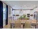 Bright dining area with a wooden table, modern lighting, and a view of the kitchen at 2512 Stonington Dr, Cary, NC 27523