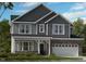 Charming craftsman-style home with stone accents, gray siding, and a welcoming covered porch at 2512 Stonington Dr, Cary, NC 27523