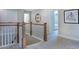 Upstairs hallway with wood railing, neutral carpet, and access to rooms at 2512 Stonington Dr, Cary, NC 27523