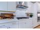Bright kitchen features stainless steel hood, white cabinets, and subway tile backsplash at 2512 Stonington Dr, Cary, NC 27523