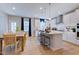 Bright kitchen and dining area with a kitchen island, bar stool seating, and wood floors at 2512 Stonington Dr, Cary, NC 27523