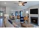 Open-concept living room featuring a fireplace, wood floors, and stylish furnishings at 2512 Stonington Dr, Cary, NC 27523