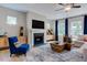 Comfortable living room features a fireplace, large windows, and stylish furnishings at 2512 Stonington Dr, Cary, NC 27523