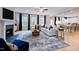 Open-concept living room with a fireplace, wood floors, and plenty of natural light at 2512 Stonington Dr, Cary, NC 27523