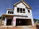 Exterior view of a two-story home under construction, framed, and wrapped, showcasing architectural details at 252 Meadowbark Bnd # 46, Garner, NC 27529