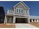 Two-story home under construction with gray siding and a spacious garage at 252 Meadowbark Bnd # 46, Garner, NC 27529