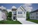 Charming two-story home with gray siding, white trim, a two-car garage, and a well-manicured lawn at 252 Meadowbark Bnd # 46, Garner, NC 27529