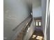 View of the hallway and staircase featuring wood railing and white walls at 252 Meadowbark Bnd # 46, Garner, NC 27529