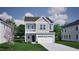 Charming two-story home featuring gray siding, white trim, a balcony, and an attached two-car garage at 263 Meadowbark Bnd # 33, Garner, NC 27529