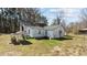 Rear exterior of the home showing the white siding and surrounding yard at 2710 Morton Pulliam Rd, Roxboro, NC 27574