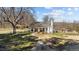 Charming front exterior featuring a covered porch with seating and a well-maintained lawn at 2710 Morton Pulliam Rd, Roxboro, NC 27574
