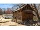 Rustic outbuilding with log cabin style and stone foundation at 2778 Morton-Pulliam Rd, Roxboro, NC 27574