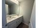 Bright bathroom featuring a double sink vanity with white cabinets and a large mirror at 285 Gregory Village Dr, Lillington, NC 27546