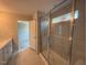 Bathroom featuring a glass enclosed shower with marble wall, a vanity, and an open doorway to bedroom at 285 Gregory Village Dr, Lillington, NC 27546