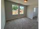 Cozy bedroom with plush carpet, natural light from windows, and neutral walls for easy personalization at 285 Gregory Village Dr, Lillington, NC 27546
