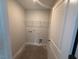 Compact laundry room featuring shelving and hookups for a washer and dryer at 285 Gregory Village Dr, Lillington, NC 27546